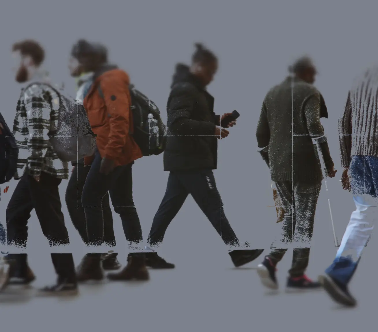 A group of people walking, some using phones, blurred faces.