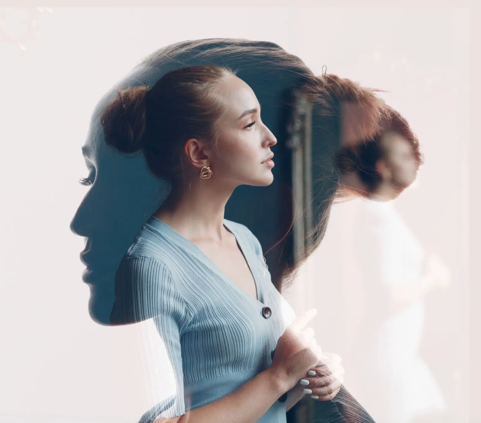 A woman in profile with a translucent double exposure effect.