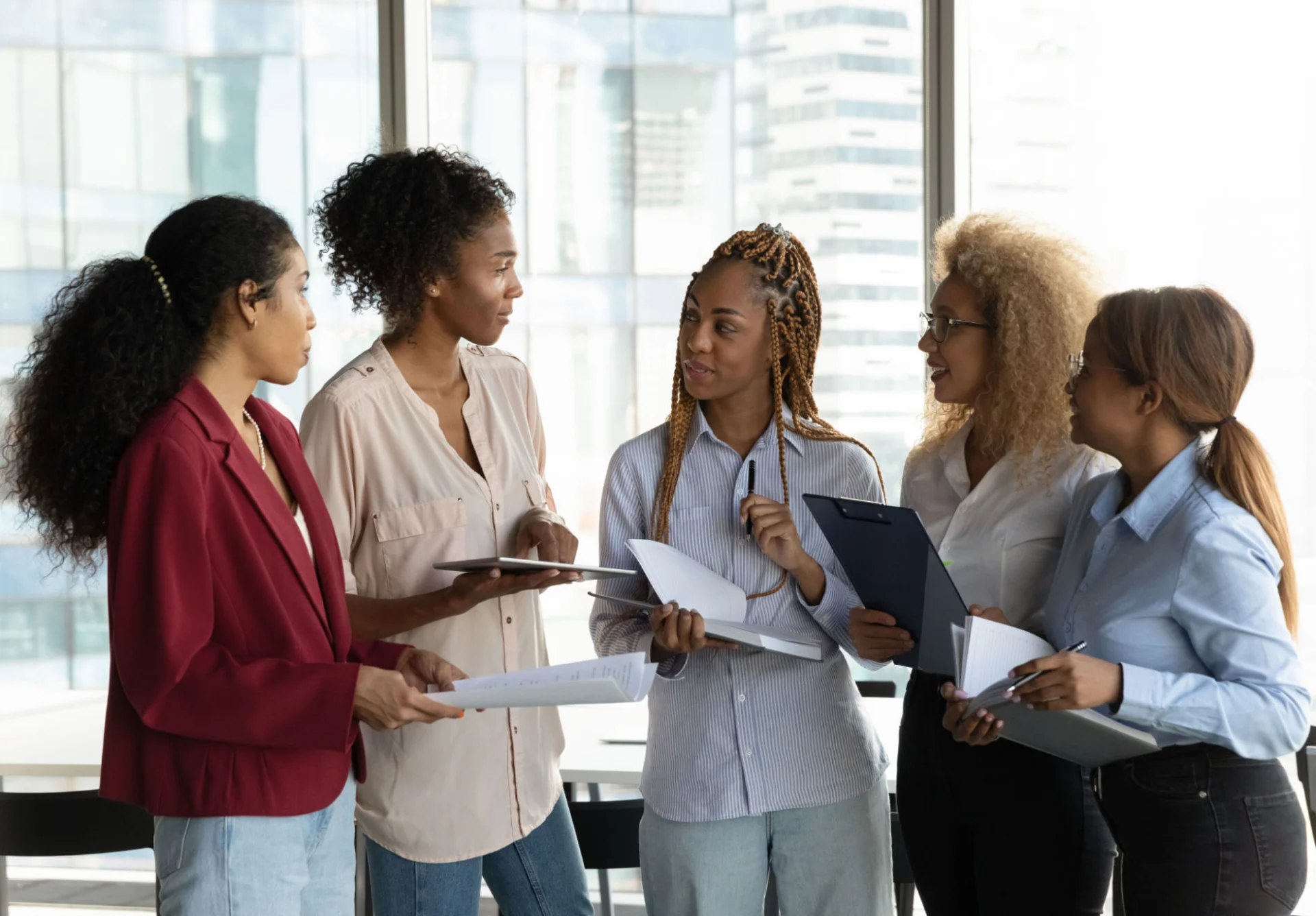 A diverse group of professionals engaged in discussion at work.