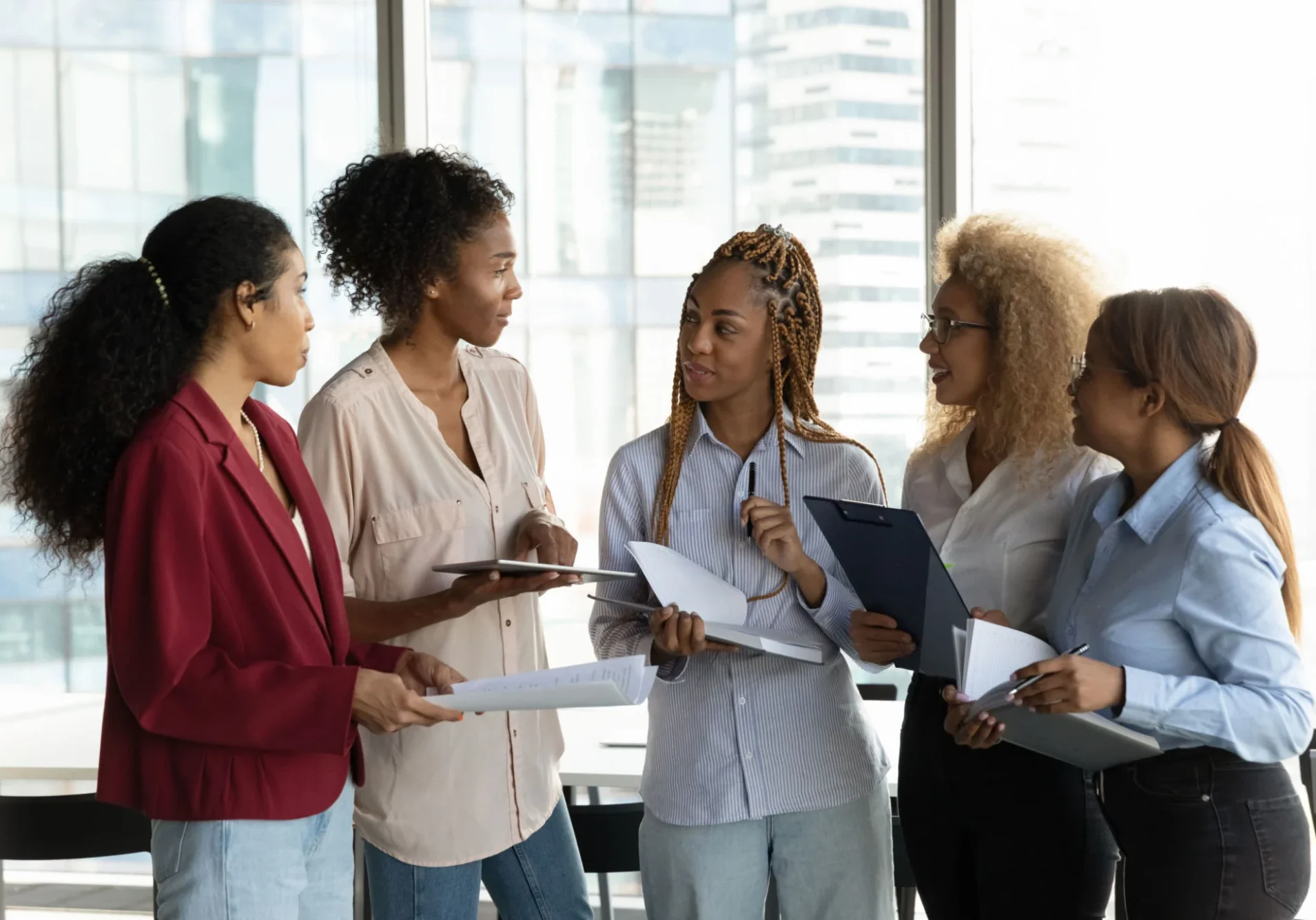A diverse group of professionals engaged in discussion at work.